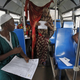 A woman prepares to cast her vote in an old bus which is used as a polling station during a presidential election in Conakry, Guinea.